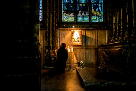 person praying in front of an altar photo