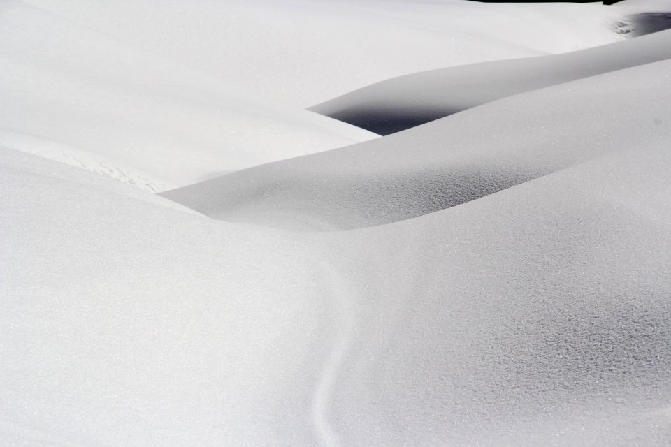 Small mountain slopes covered in white snow. photo