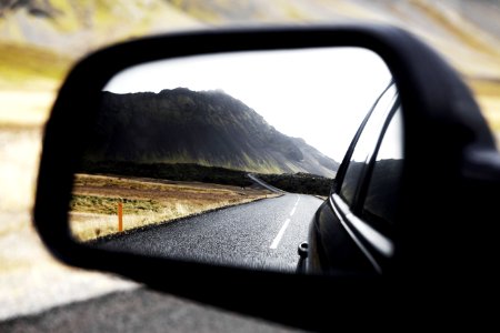 black wing mirror showing road photo