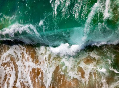 aerial photography of sea waves on seashore during daytime photo