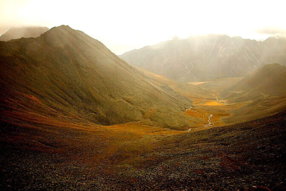 green mountains covered with fog during daytime