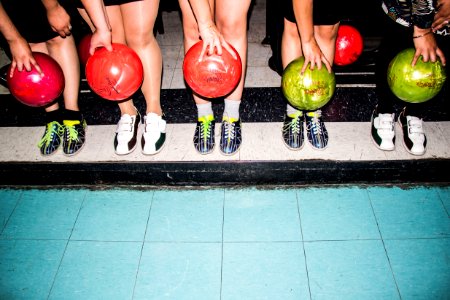 person holding bowling balls photo