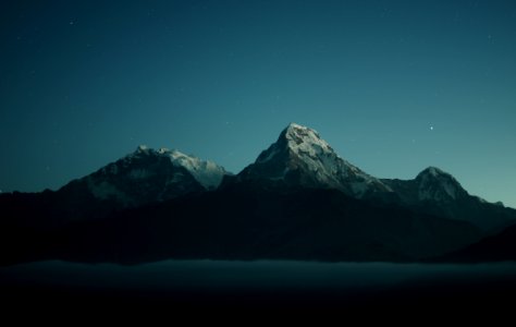 silhouette of mountains during nigh time photography photo