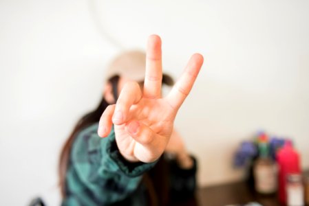 person doing peace sign photo