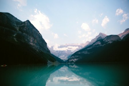 mountain range near body of water under blue skies photo