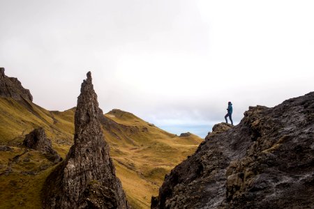 person standing on top of rock formation photo