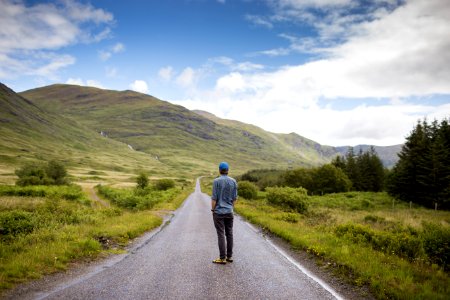 man standing on concrete road