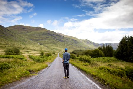 man standing on concrete road photo