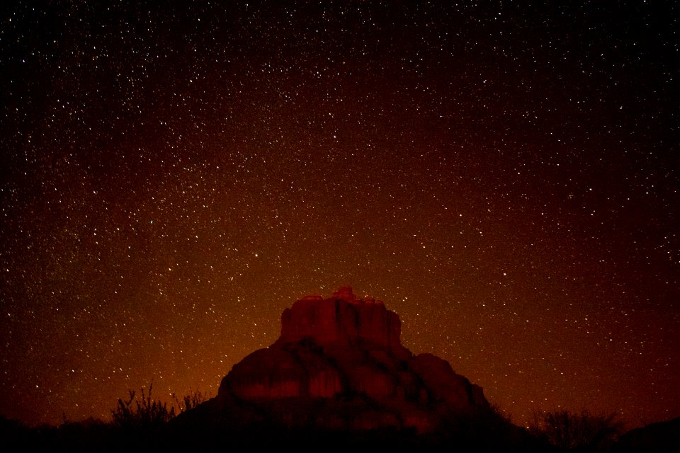 brown mountain under starry sky during nighttime in timelapse photography