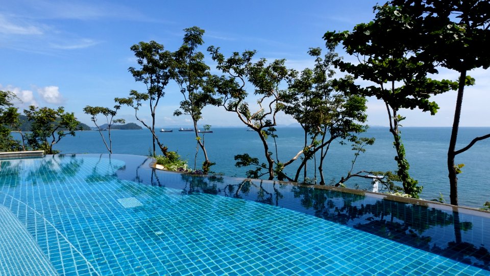 infinity pool with background view of open sea at daytime