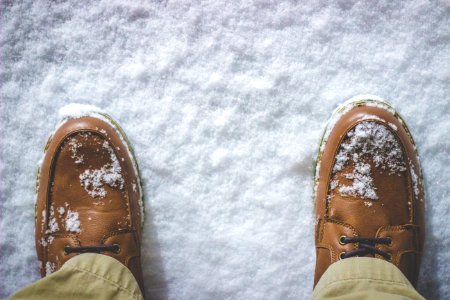 top view photography of person standing on snow covered field photo
