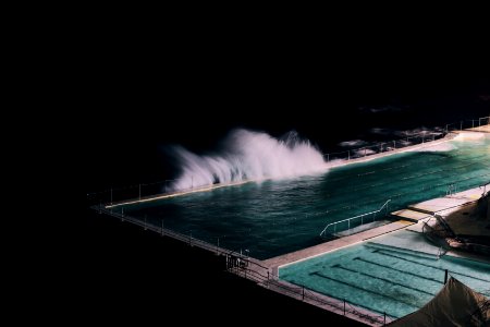rectangular blue swimming pool during night time photo
