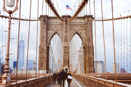 people walking on Brooklyn Bridge during daytime photo