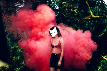 woman standing in front of red smoke photo
