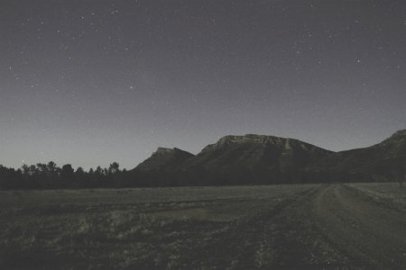 overlooking mountain during starry night photo