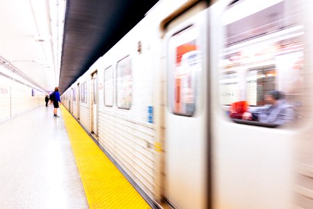 selective focus photography of person standing on train station photo