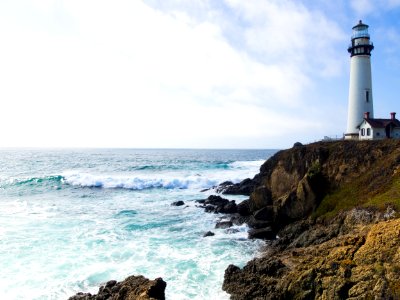 photo of lighthouse on cliff photo