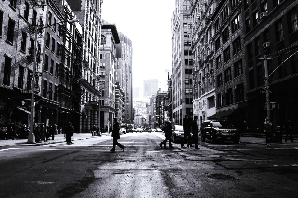 grayscale photography of people crossing the street