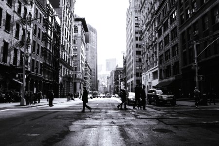 grayscale photography of people crossing the street photo