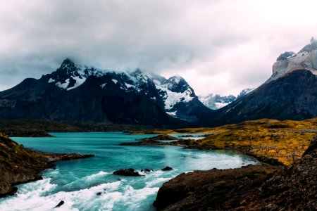 body of water surrounded by mountains photo