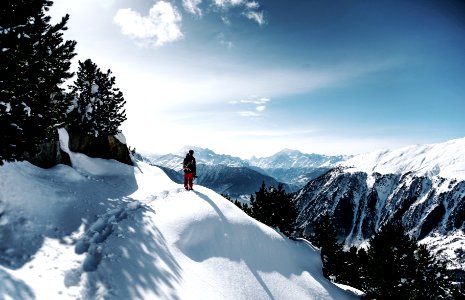 person walking on snowy mountain during daytime photo
