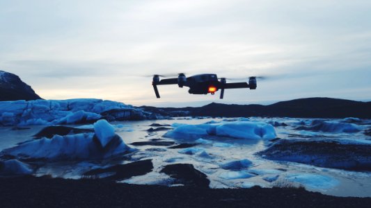 drone flying on body of water photo