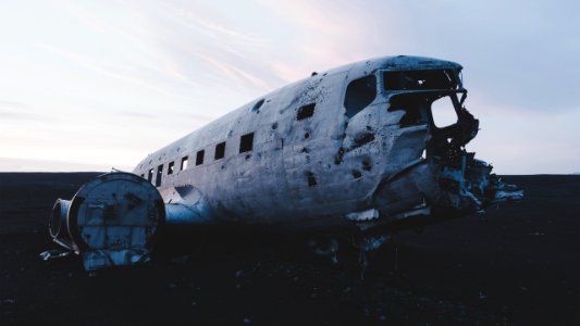 abandoned airplane on the floor under white clouds photo