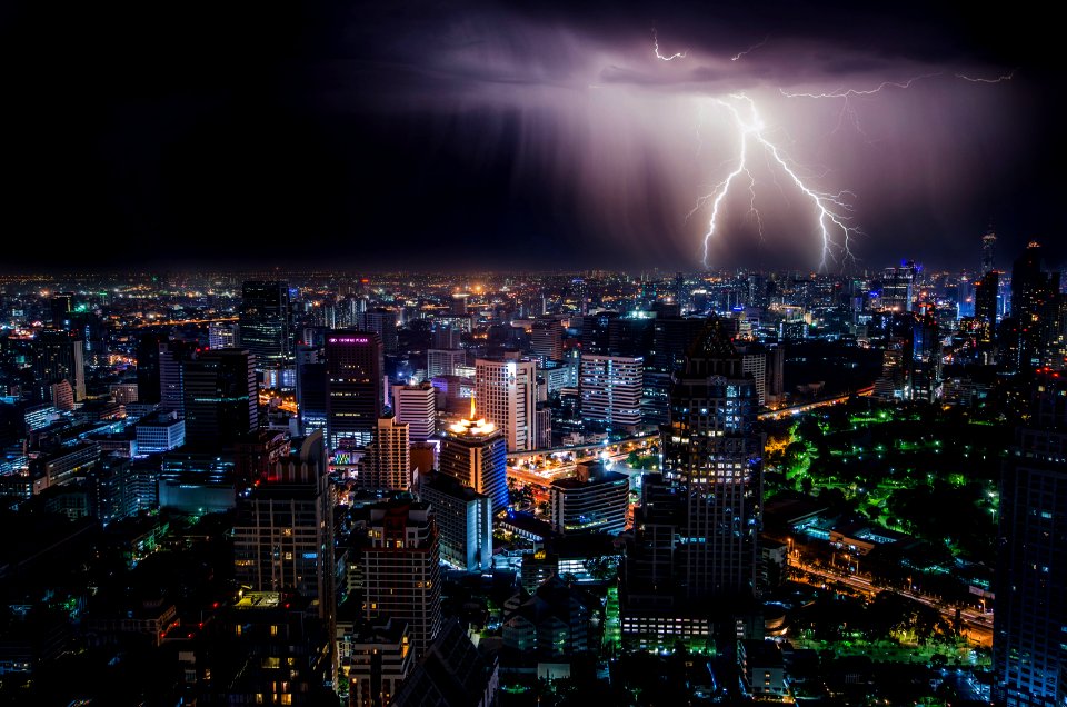 aerial view of city buildings with lightning strike