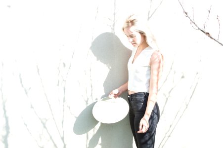 woman leaning on white board