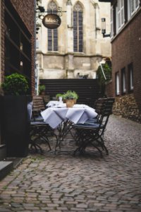 empty patio sets beside shop during day