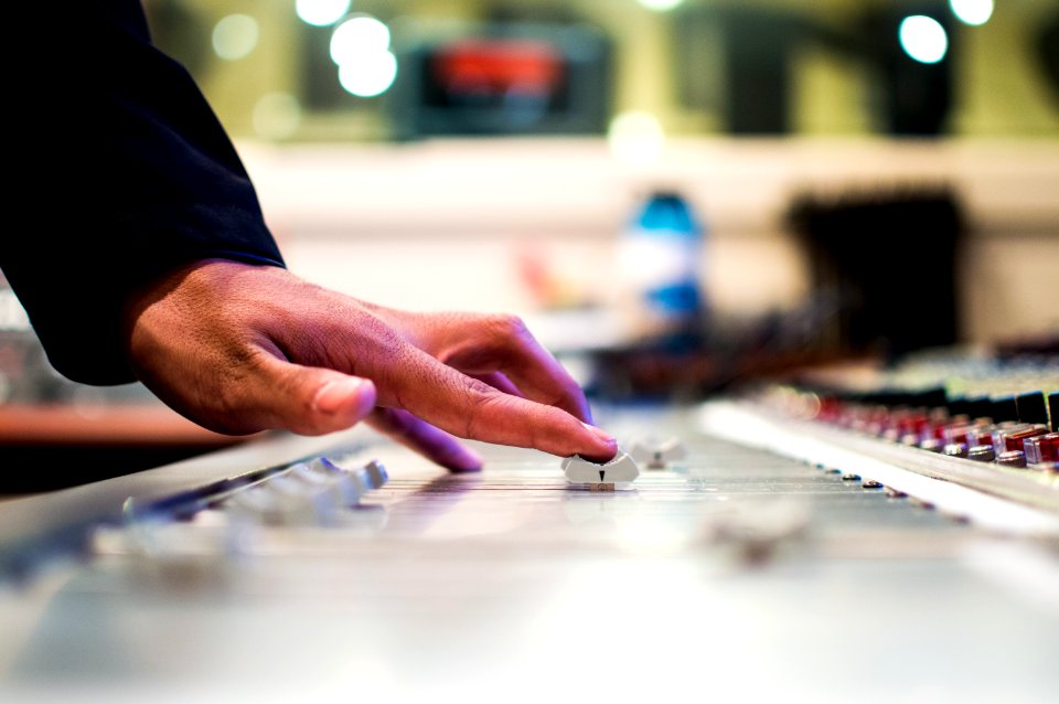 person holding mixing console