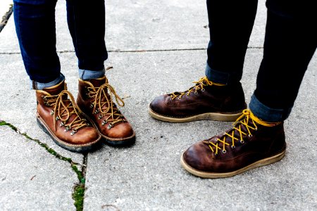 two person wearing brown leather boots photo