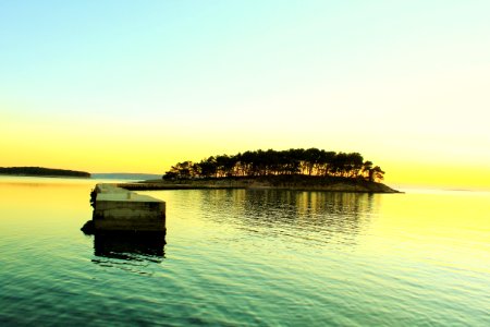 landscape photography of island in middle of body of water
