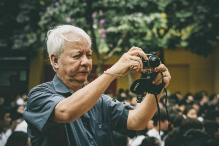 man holding camera photo