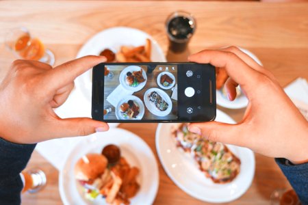 person taking picture of the foods photo