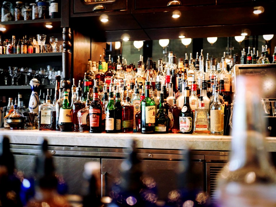 liquor bottles on white and brown wooden cabinet