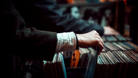 person picking up the music record