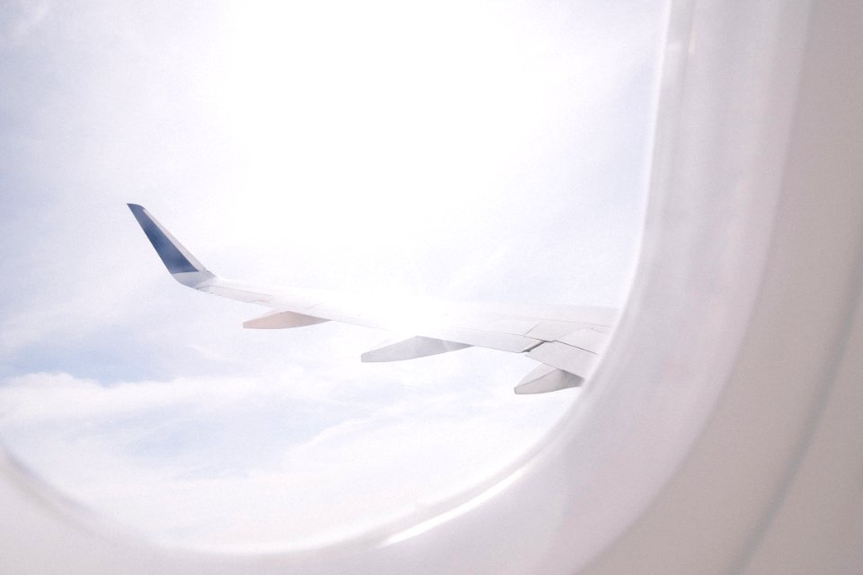 airplane flying over cloud during daytime