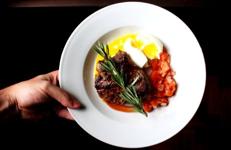 person holding white ceramic plate