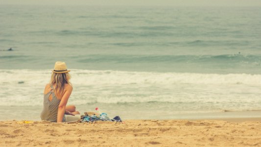 woman sitting on seashore photo