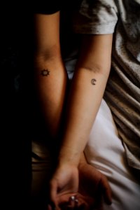 two persons showing their hand tattoos photo