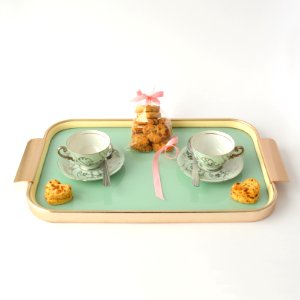 rectangular beige and green tea set and packed cookies