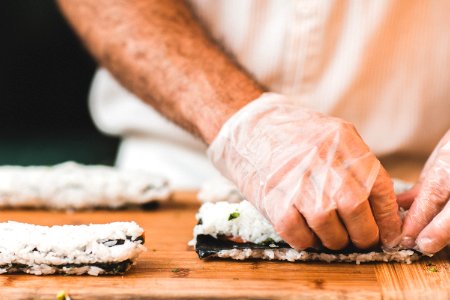 person making sushi