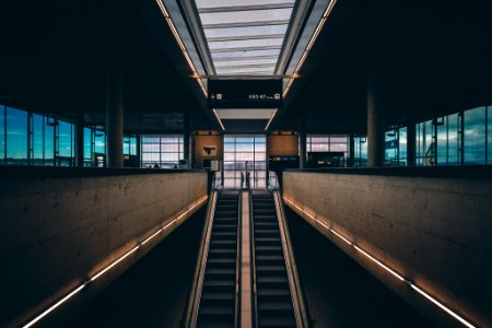 black and brown escalator inside building photo