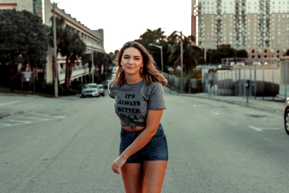 woman walking in the middle of the road photo