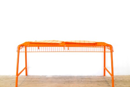 orange steel scaffolding on brown surface