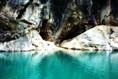 rock formation with blue water photo