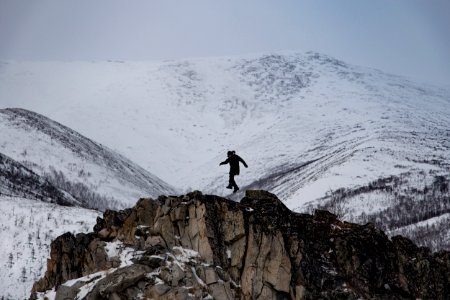man climbing mountain of snow photo