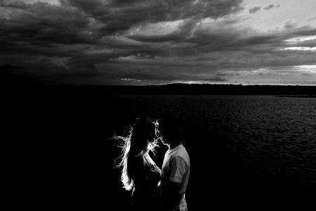 grayscale photo of couples near body of water