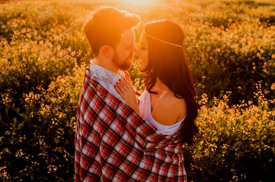 man hugging woman surrounded by plants